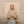Load image into Gallery viewer, Woman in a beige sweater standing against a beige 
